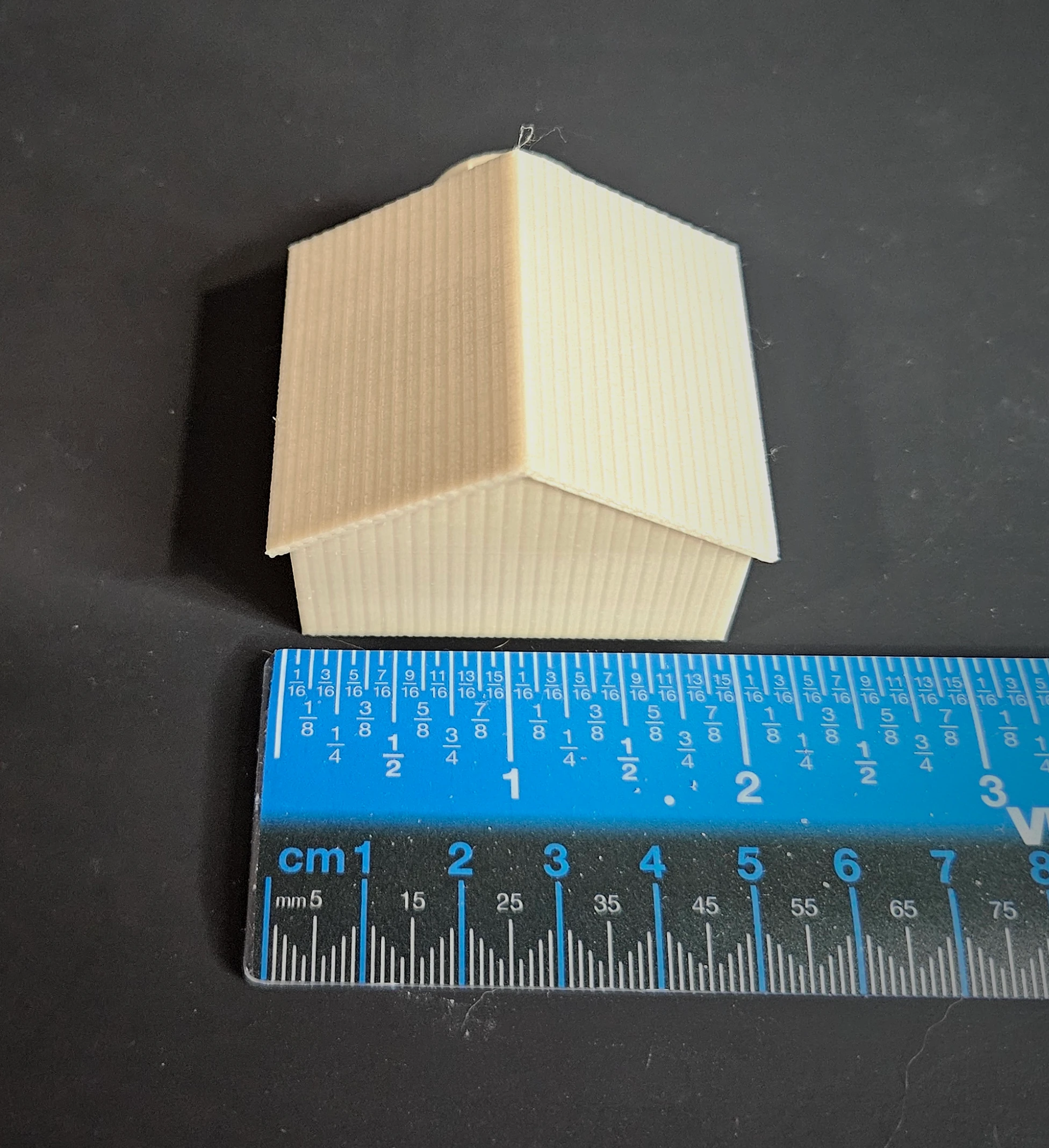 Finished scenic example of N scale waterwheel with large building